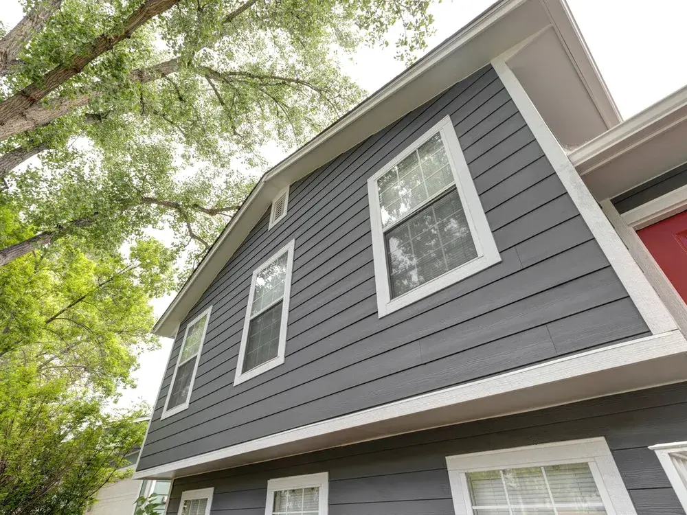 Siding installer fitting new exterior panels on a Minnesota home in Eden Prairie, MN