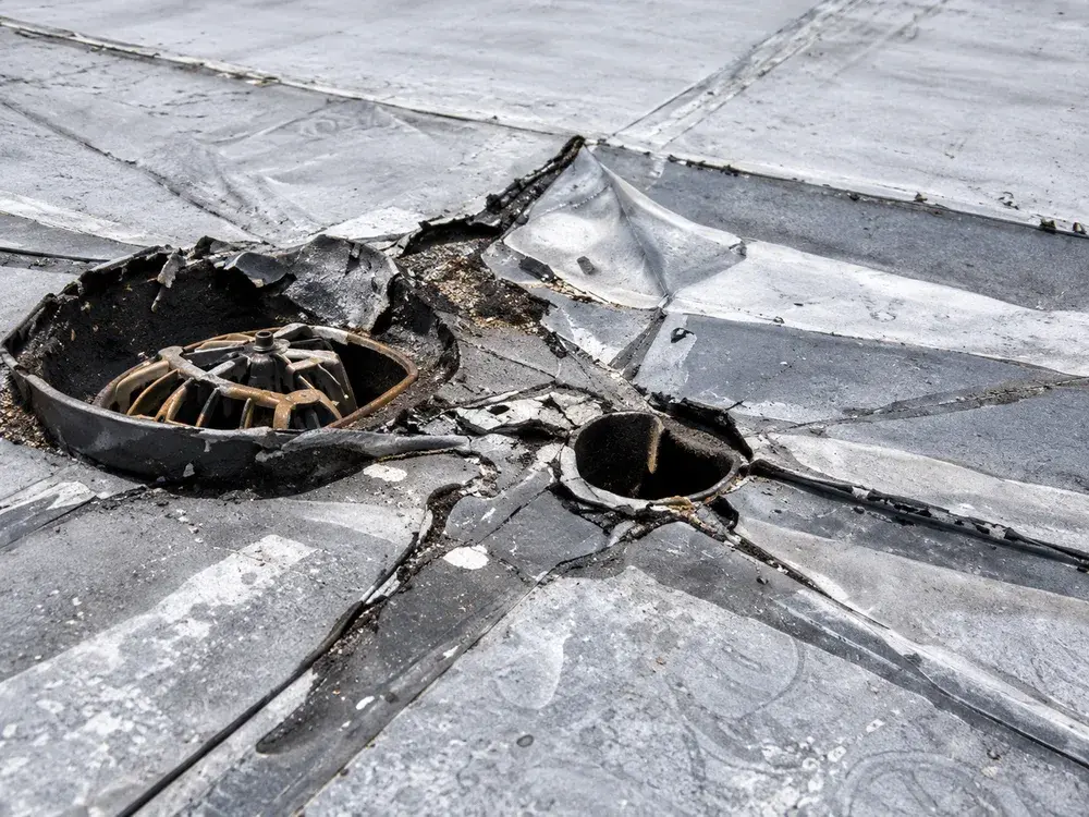 Damaged drain and open membrane seam on a commercial roof in Eden Prairie, MN Damaged drain and open membrane seam on a commercial roof in Eden Prairie, MN