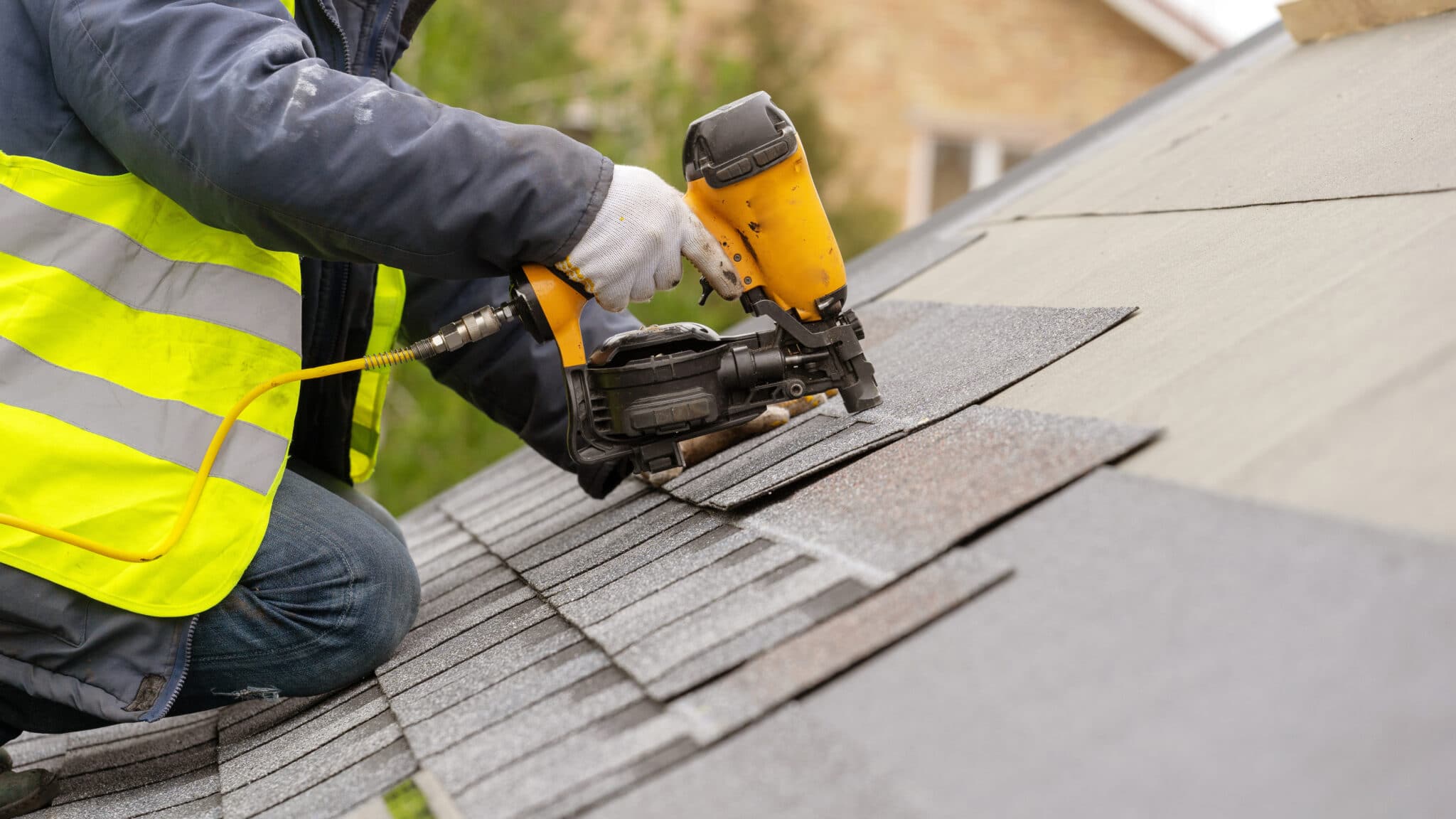Roofing professionals aligning new shingles and flashing for precise full roof installation